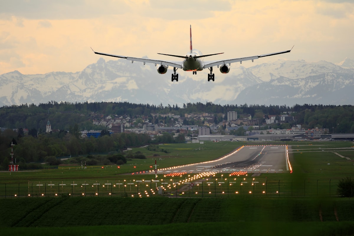 Commercial aircraft on tarmac at sunset