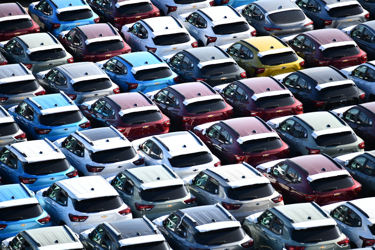 Rows of new cars parked in a dealership lot